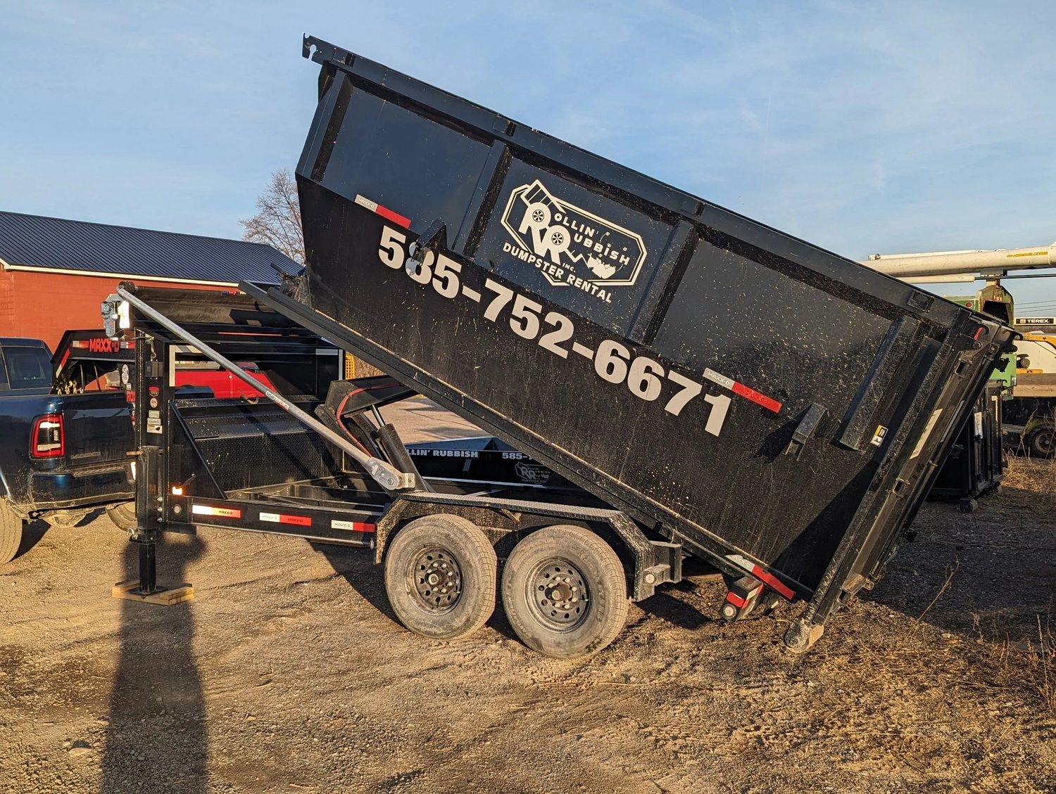 Rollin' Rubbish dumpster tilted for drop-off