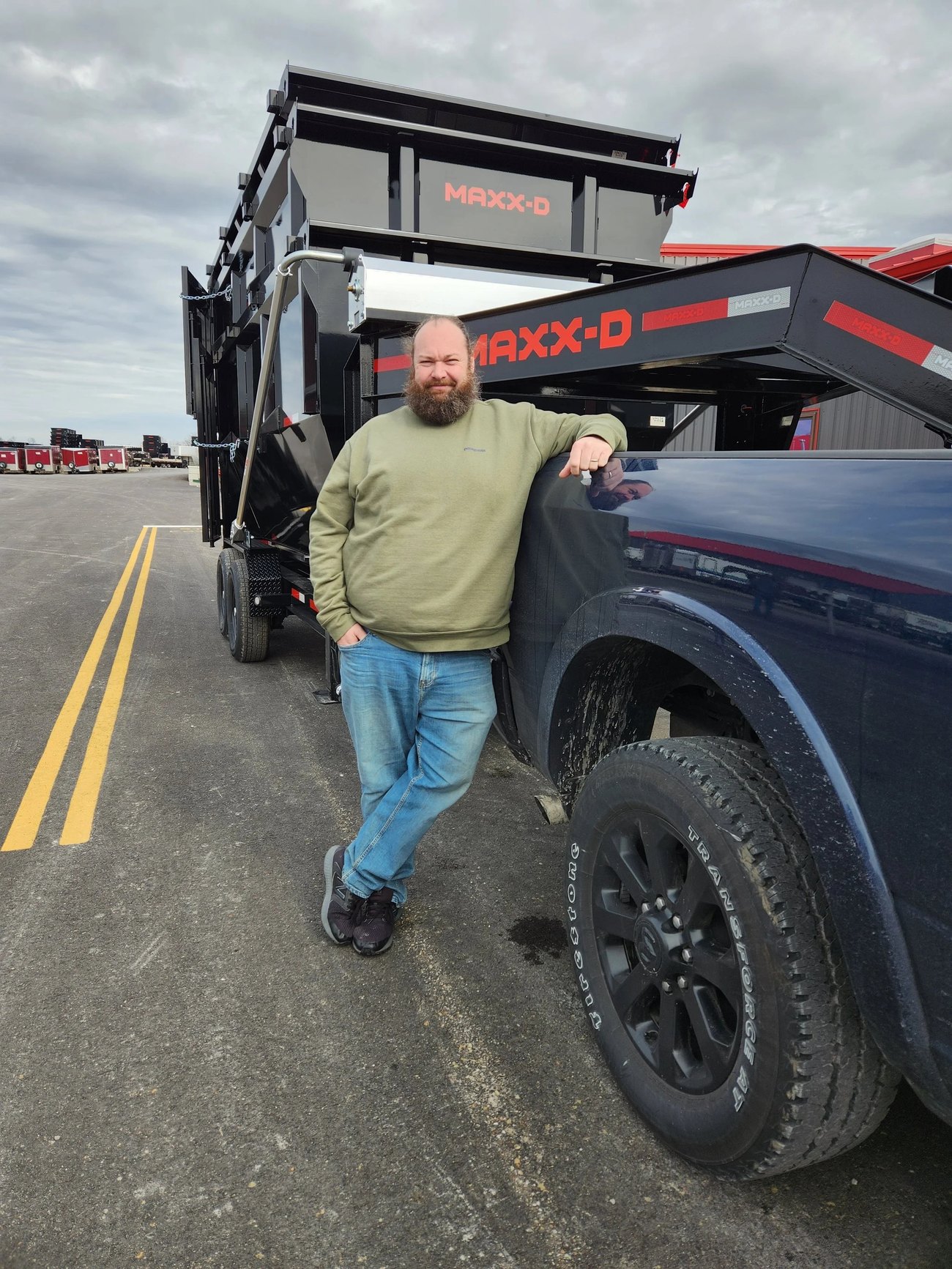 Adam, owner of Rollin' Rubbish, beside a MAXX-D dump trailer and truck